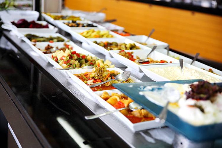 Stainless steel Trays full of Food.